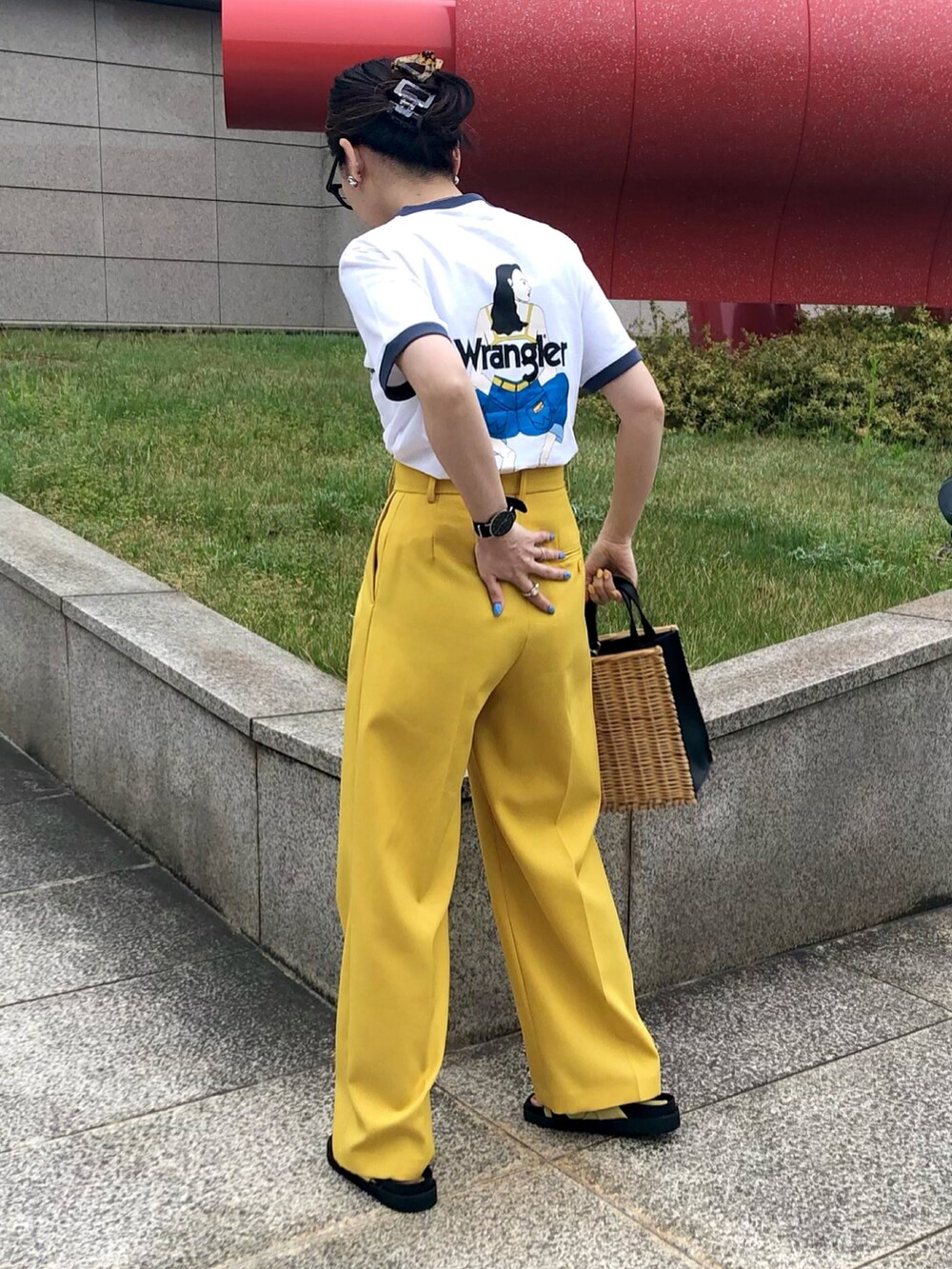ホワイト系のTシャツ/カットソー、イエロー系のスラックス、ブラック系のトートバッグを着用したレディースの春コーディネートの2枚目の写真