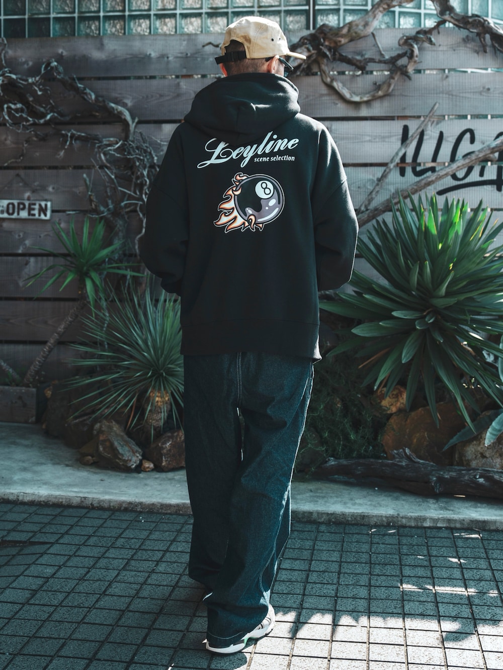 ブラック系のパーカー、ベージュ系のスニーカー、ベージュ系のキャップを着用したメンズの春コーディネートの2枚目の写真