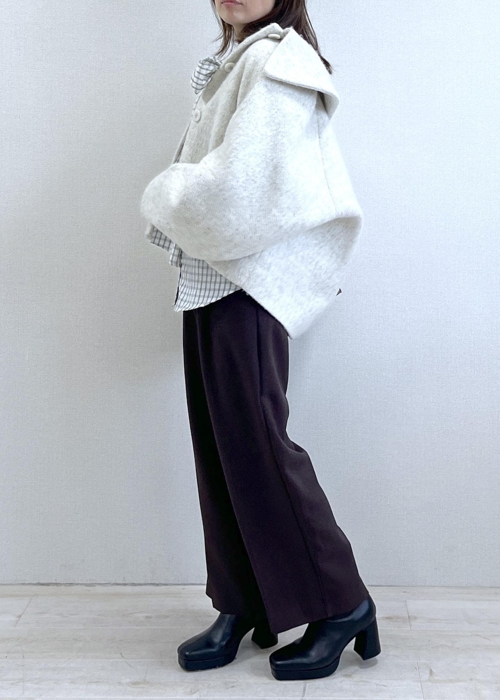 ブラック系のブーツ、ホワイト系のシャツ/ブラウス、ホワイト系のブルゾンを着用したレディースの秋コーディネートの3枚目の写真