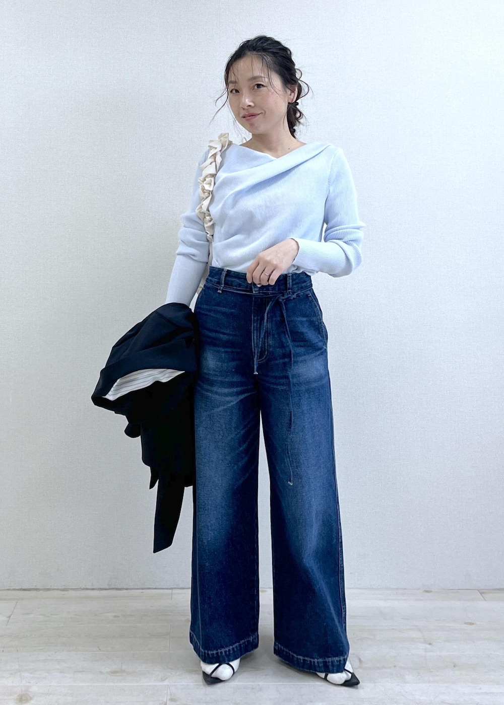 ブルー系のテーラードジャケット、ブルー系のデニムパンツ、ホワイト系のショルダーバッグを着用したレディースの冬コーディネートの5枚目の写真