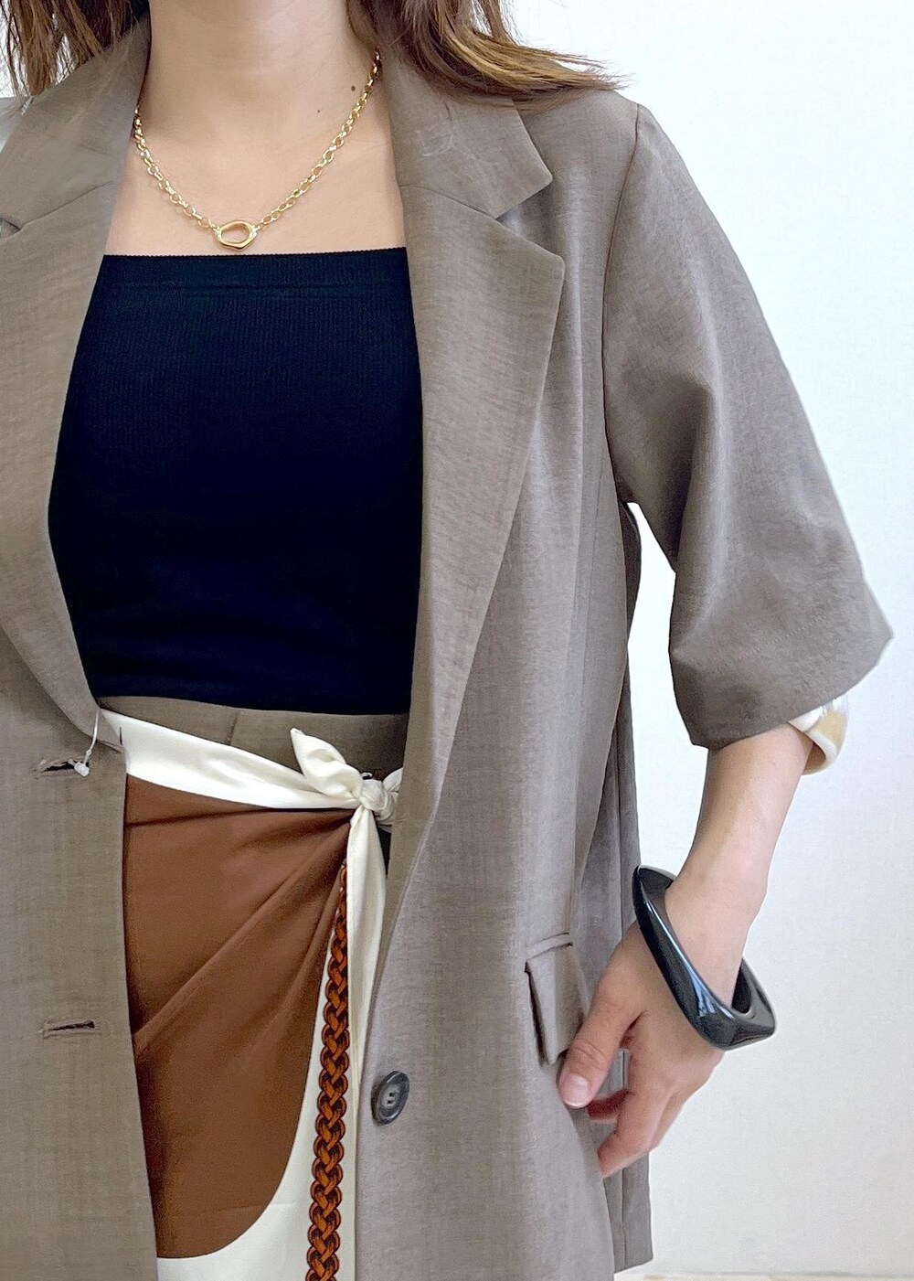 ブラック系のキャミソール、シルバー系のショルダーバッグ、ブラック系のサンダルを着用したレディースの春コーディネートの5枚目の写真