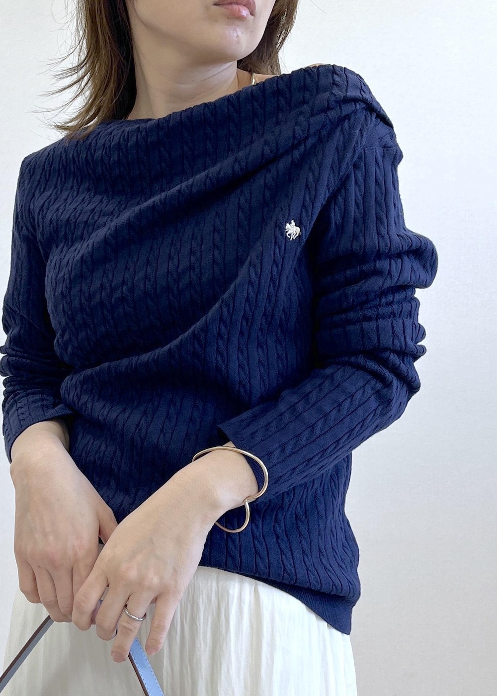 ブラック系のパンプス、ブルー系のショルダーバッグ、ベージュ系のトレンチコートを着用したレディースの春コーディネートの6枚目の写真