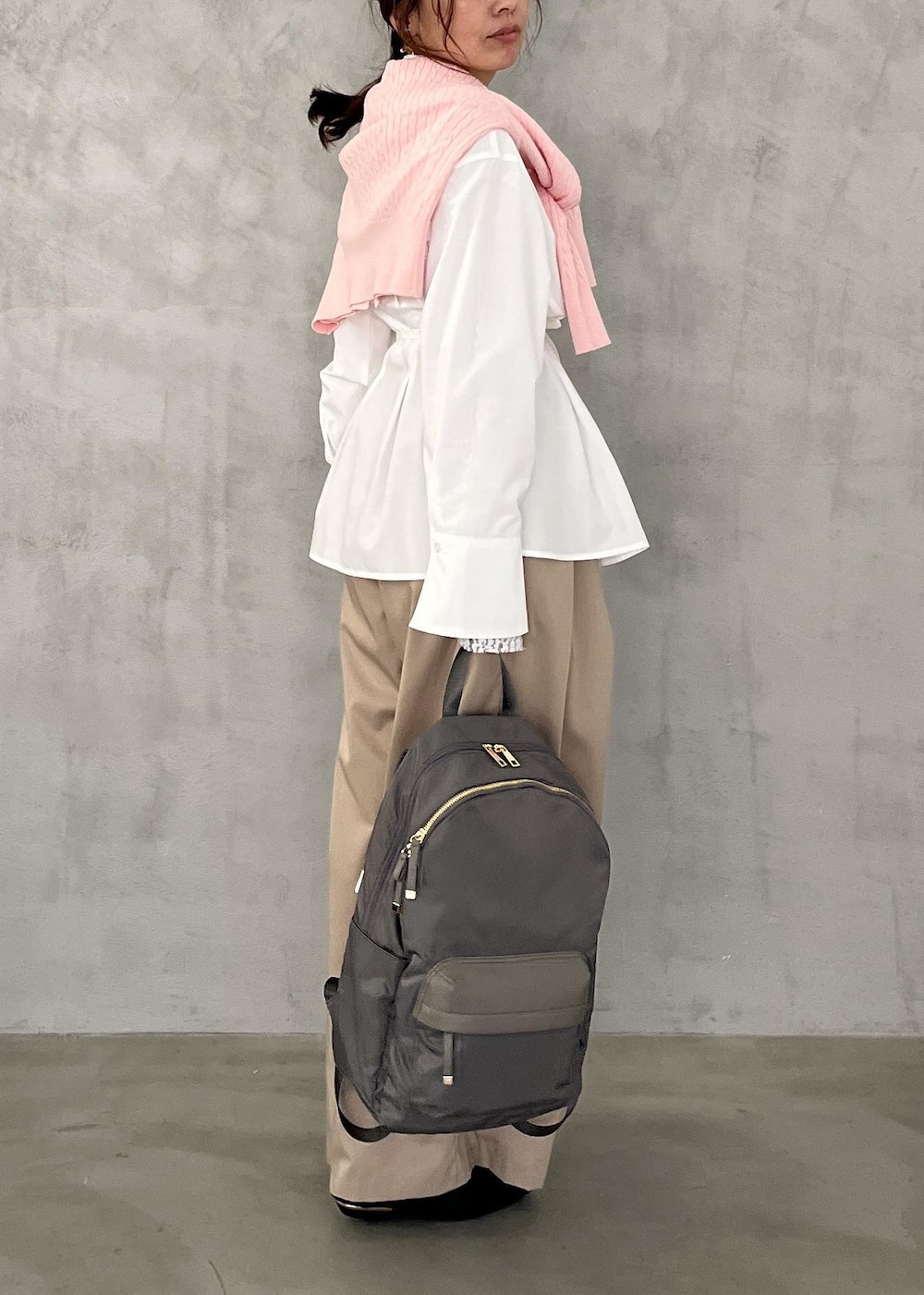 ブラック系のパンプス、ベージュ系のその他パンツ、グレー系のバックパック/リュックを着用したレディースの冬コーディネートの3枚目の写真