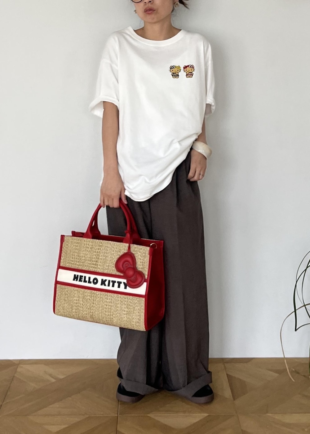 レッド系のトートバッグ、ホワイト系のTシャツ/カットソーを着用したレディースの夏コーディネートの9枚目の写真