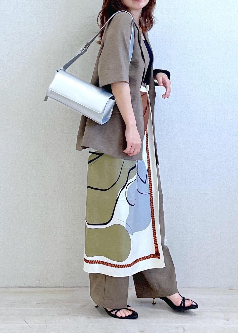 ブラック系のキャミソール、シルバー系のショルダーバッグ、ブラック系のサンダルを着用したレディースの春コーディネートの3枚目の写真