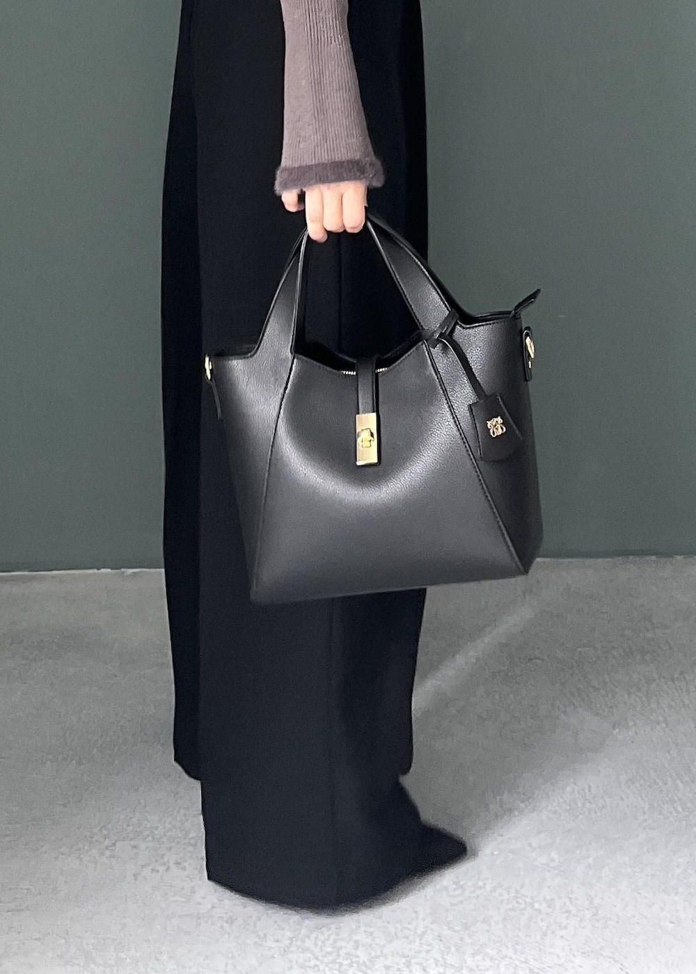 グレー系のニット/セーター、ブラック系のその他パンツ、ブラック系のテーラードジャケットを着用したレディースの秋コーディネートの10枚目の写真