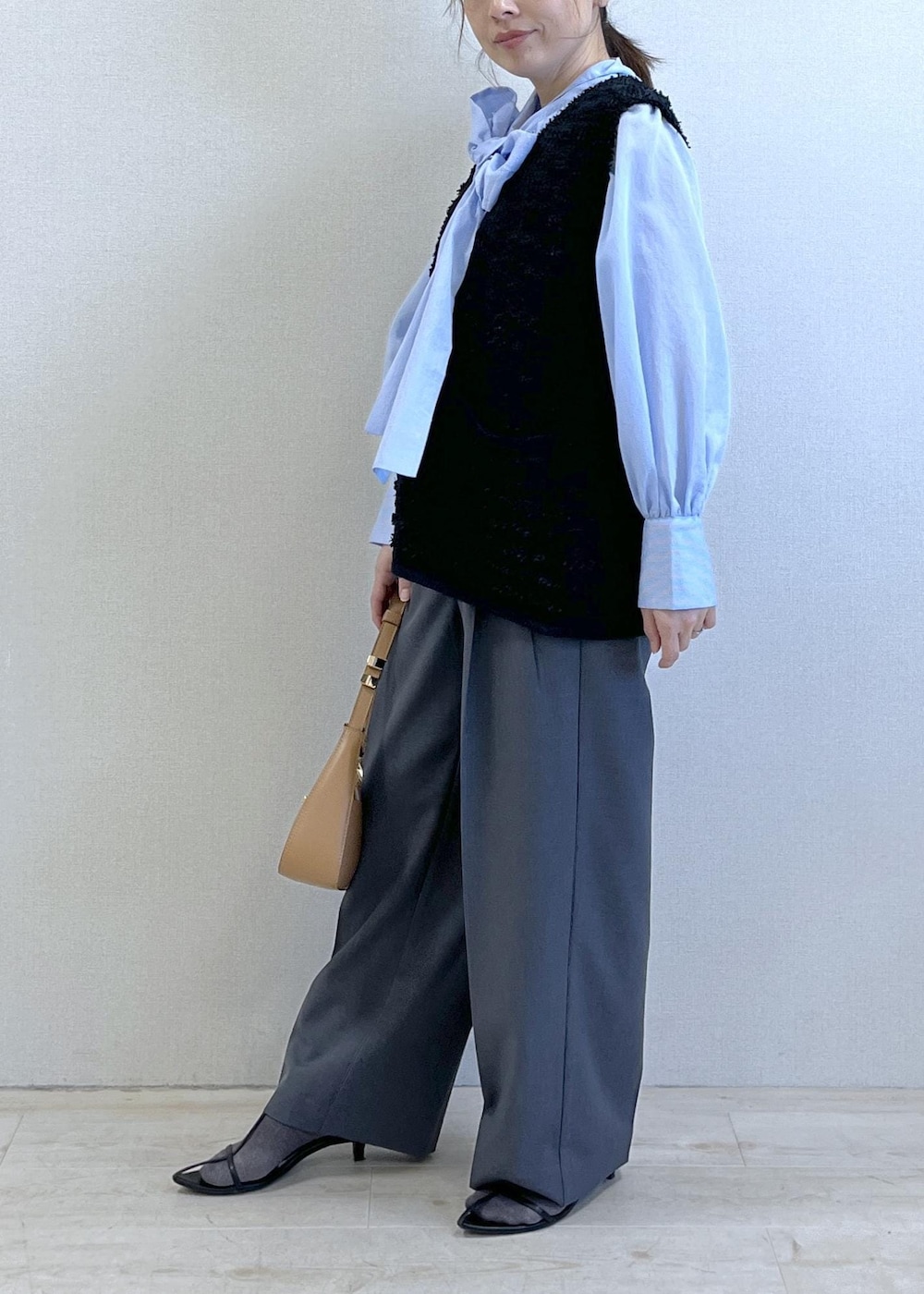 グレー系のその他パンツ、ブルー系のシャツ/ブラウス、イエロー系のショルダーバッグを着用したレディースの冬コーディネートの3枚目の写真