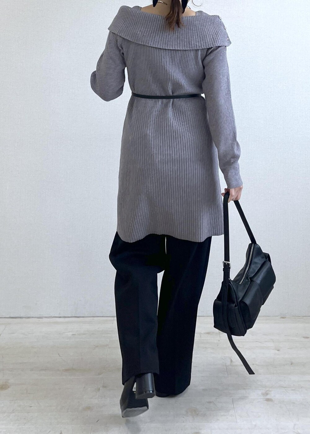 ブラック系のスラックス、ブラック系のショルダーバッグ、ブラック系のブーツを着用したレディースの秋コーディネートの4枚目の写真