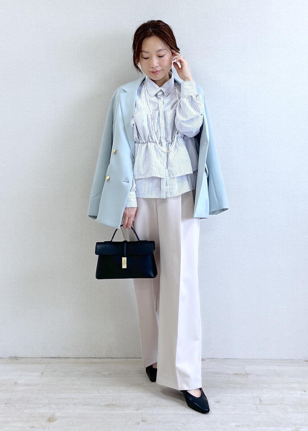 ブラック系のショルダーバッグ、グリーン系のテーラードジャケット、ベージュ系のその他パンツを着用したレディースの春コーディネートの6枚目の写真