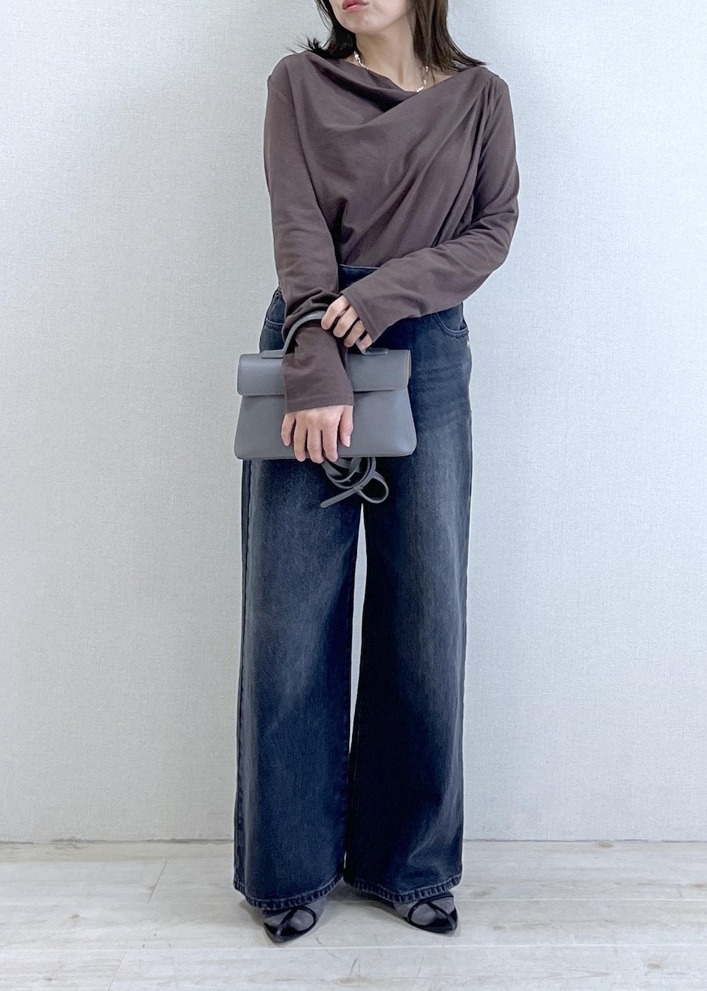 グレー系のショルダーバッグ、ブラウン系のTシャツ/カットソー、グレー系のデニムパンツを着用したレディースの秋コーディネートの8枚目の写真