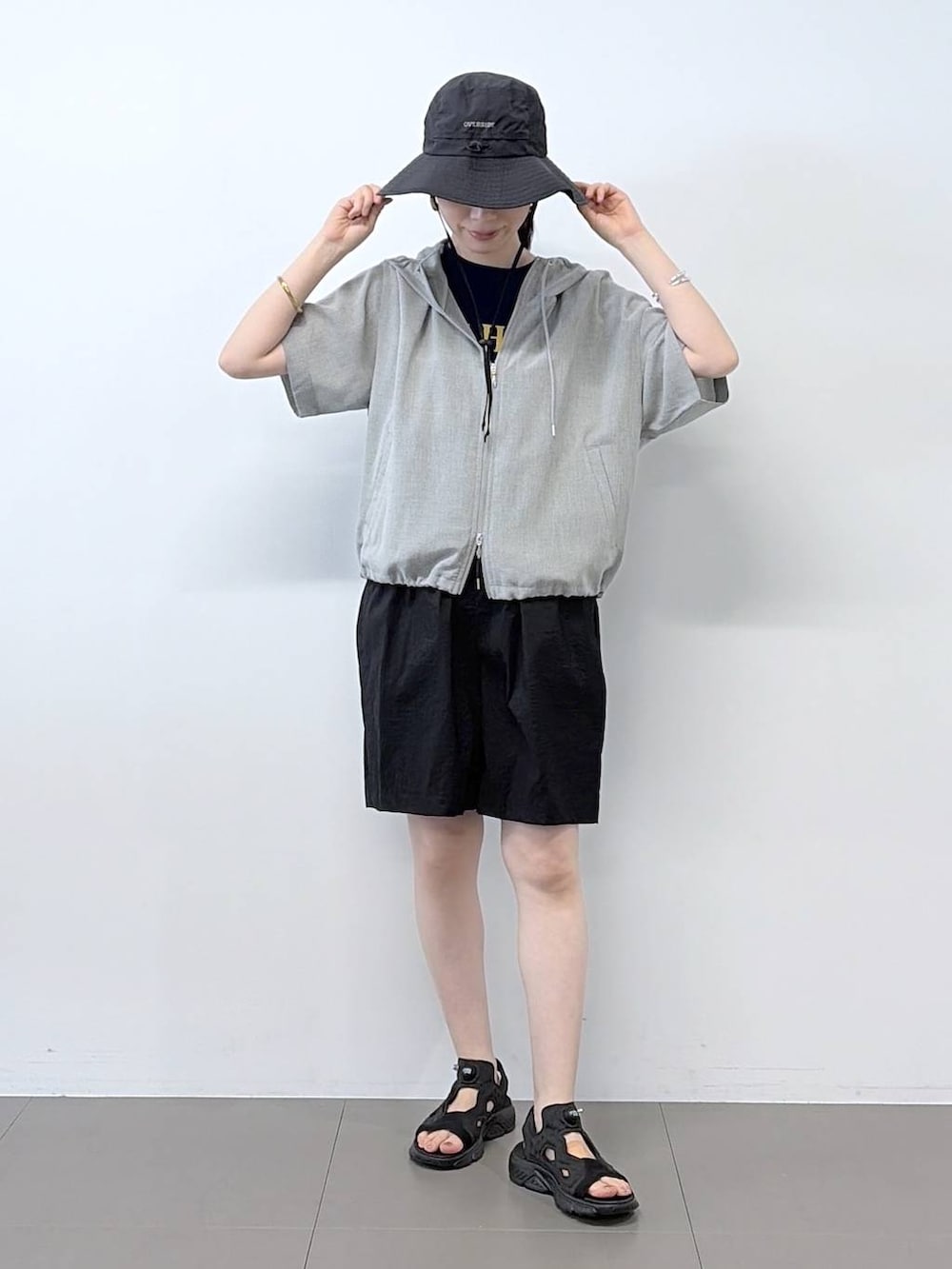 ブルー系のTシャツ/カットソー、ブラック系のその他パンツ、グレー系のブルゾンを着用したレディースの夏コーディネートの3枚目の写真