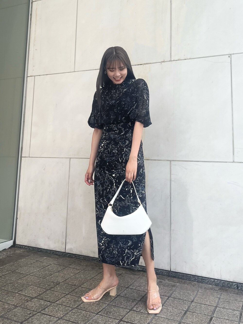 ブラック系のワンピースを着用したレディースの夏コーディネートの2枚目の写真