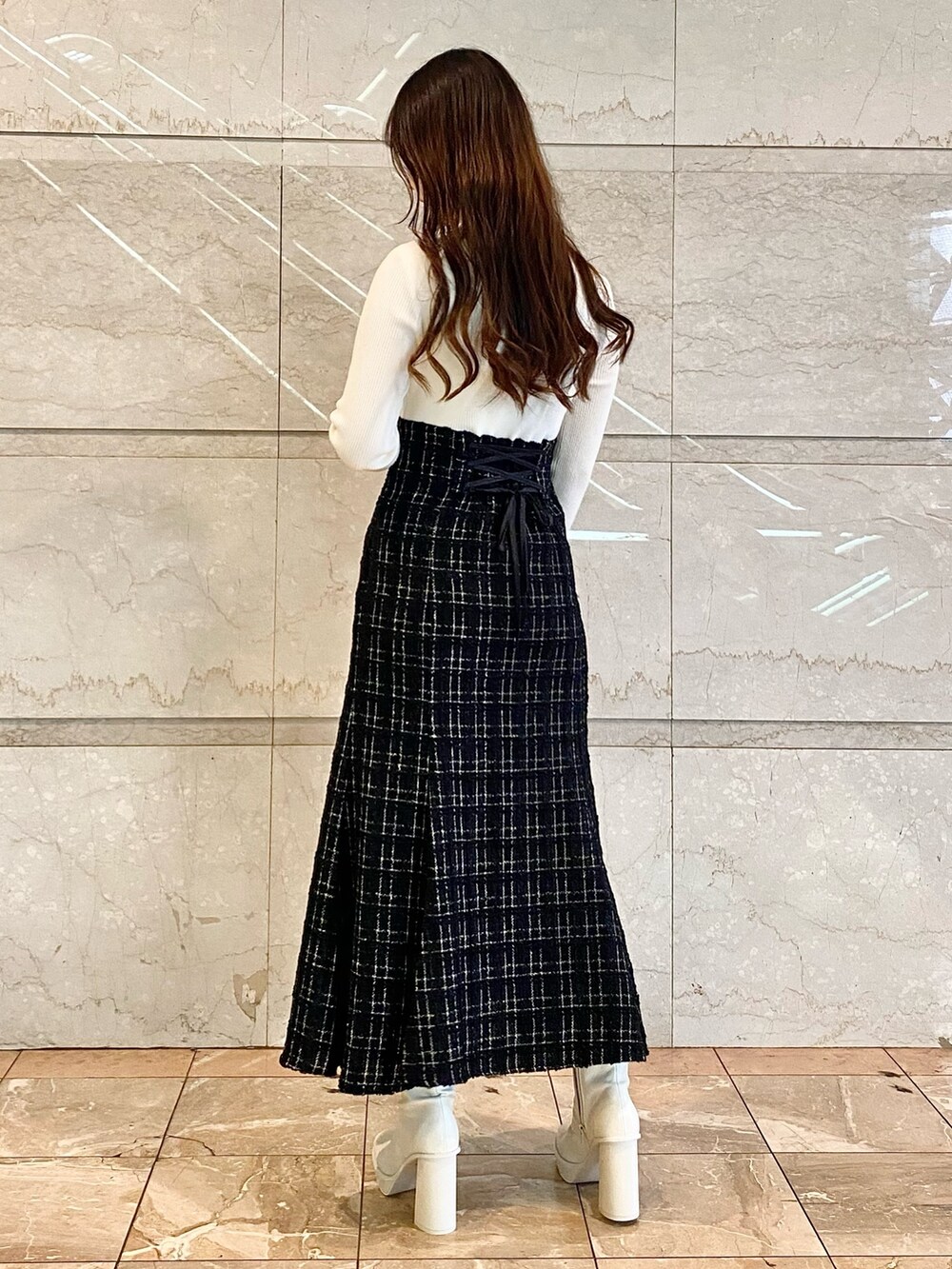 ブラック系のワンピース、ホワイト系のブーツを着用したレディースの秋コーディネートの4枚目の写真