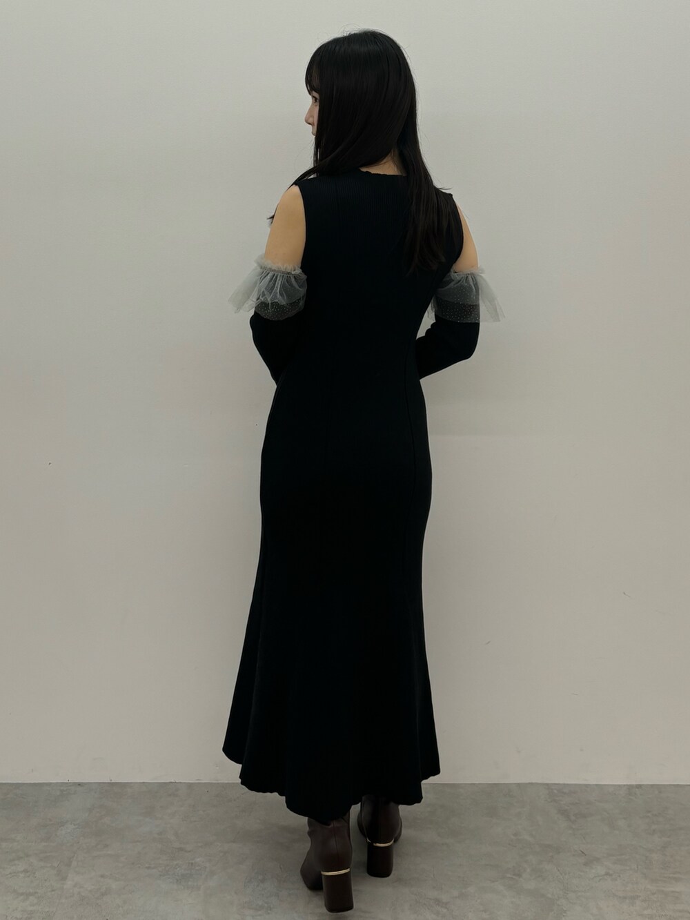 ブラック系のワンピース、ブラウン系のブーツを着用したレディースの秋コーディネートの2枚目の写真