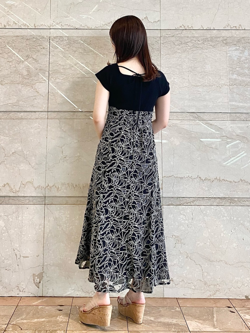 ブラック系のハンドバッグ、その他のサンダル、ブラック系のワンピースを着用したレディースの春コーディネートの4枚目の写真