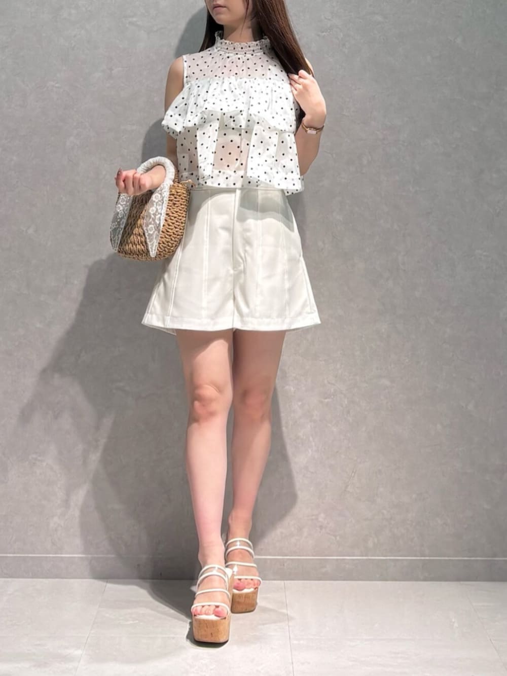 ベージュ系のハンドバッグ、その他のサンダル、ホワイト系のその他パンツを着用したレディースの夏コーディネートの2枚目の写真