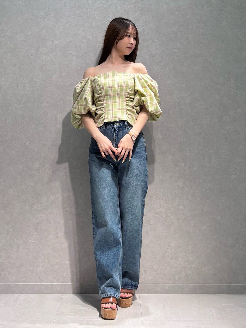 ブルー系のデニムパンツ、ブラウン系のサンダル、グリーン系のシャツ/ブラウスを着用したレディースの春コーディネートの3枚目の写真