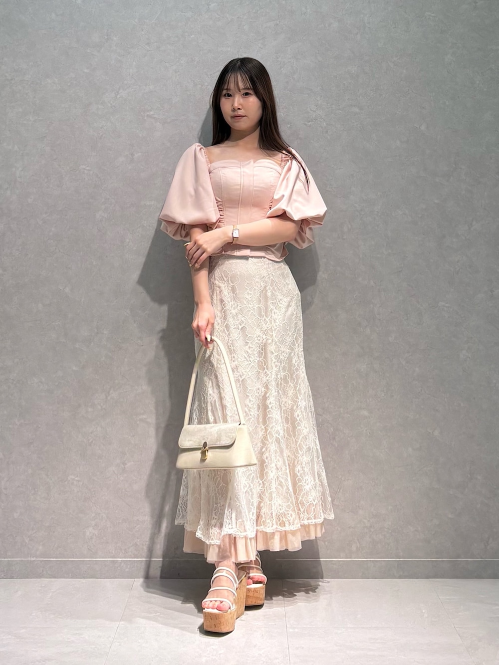ホワイト系のハンドバッグ、ホワイト系のスカート、ピンク系のシャツ/ブラウスを着用したレディースの夏コーディネートの2枚目の写真