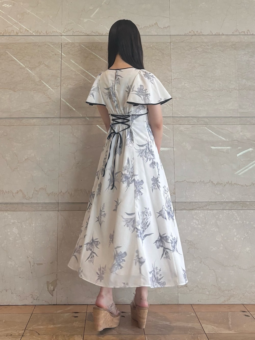 ホワイト系のワンピース、その他のサンダル、ブラック系のハンドバッグを着用したレディースの夏コーディネートの3枚目の写真