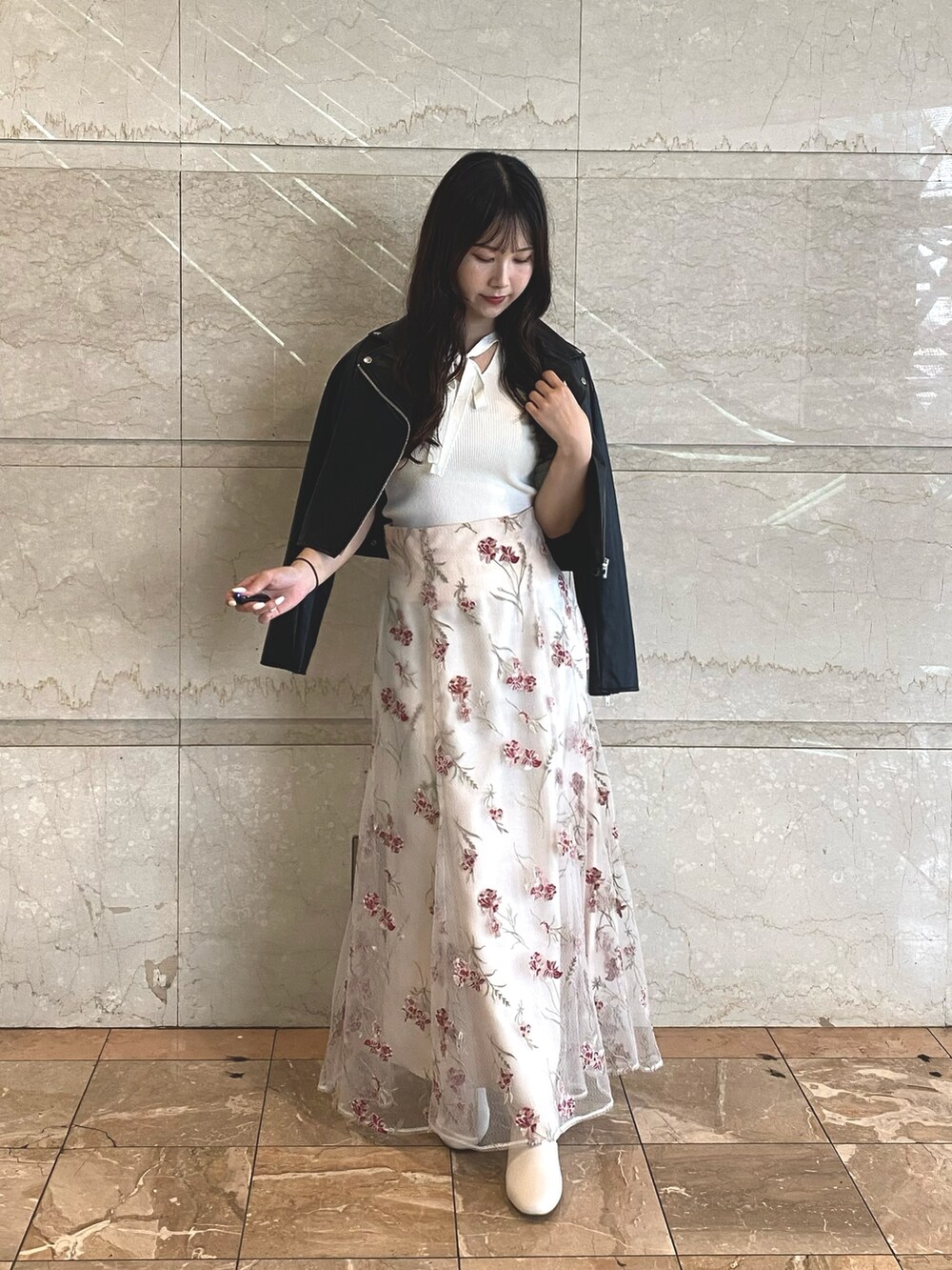 ピンク系のスカート、ホワイト系のブーツ、ホワイト系のニット/セーターを着用したレディースの夏コーディネートの2枚目の写真