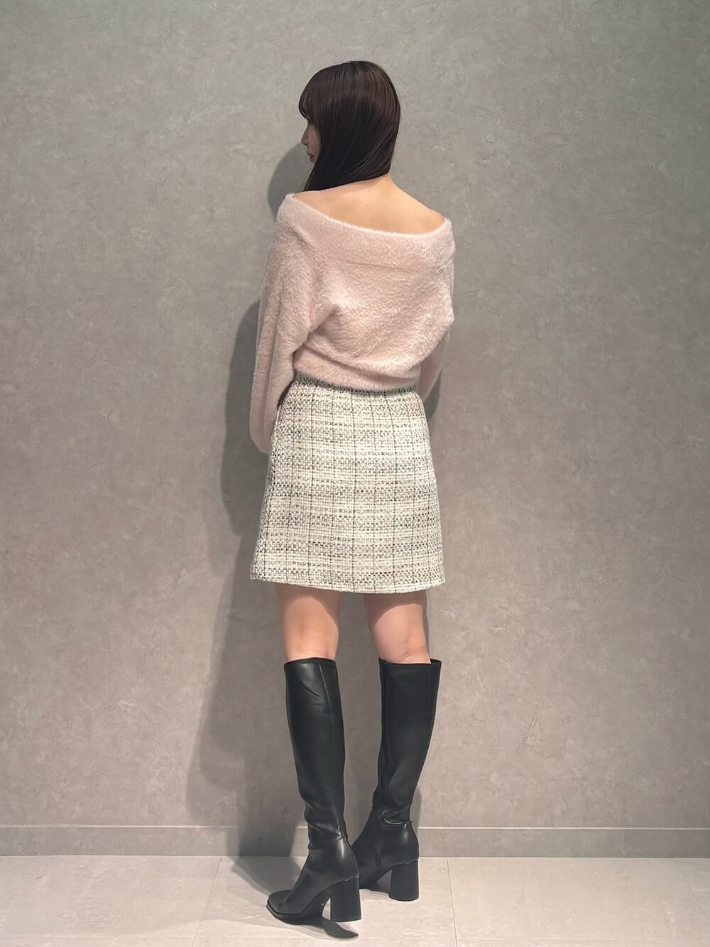 ホワイト系のスカート、ピンク系のニット/セーター、ブラック系のブーツを着用したレディースの秋コーディネートの6枚目の写真