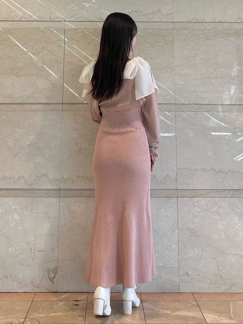 ピンク系のワンピース、ホワイト系のブーツを着用したレディースの冬コーディネートの4枚目の写真