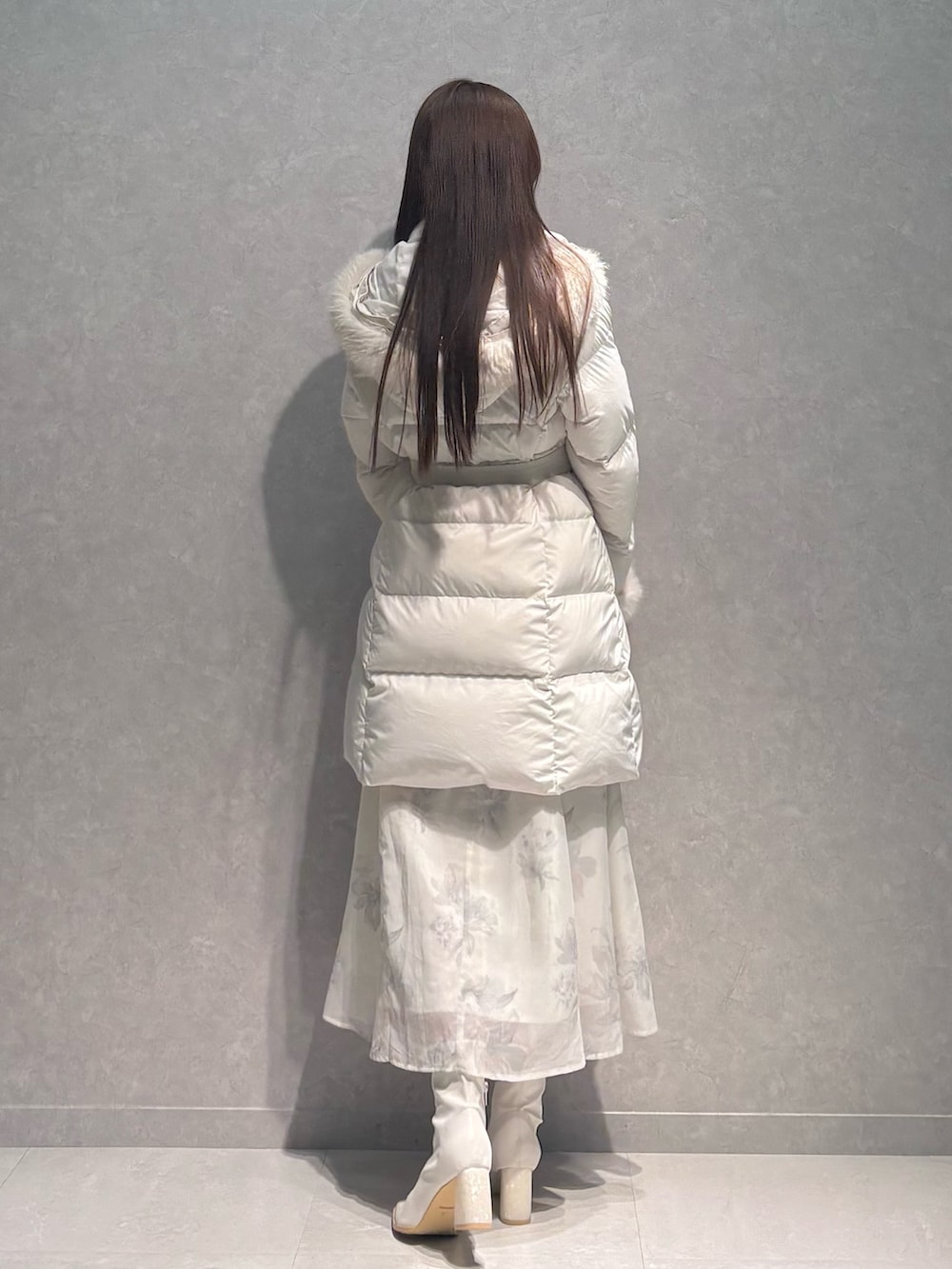 ベージュ系のワンピース、ホワイト系のダウンジャケット/コート、ホワイト系のブーツを着用したレディースの秋コーディネートの5枚目の写真