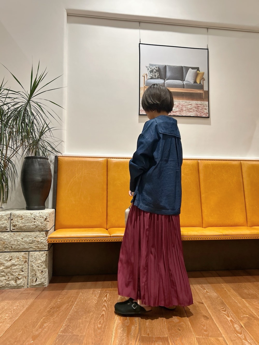 ブルー系のシャツ/ブラウス、レッド系のスカート、ブラック系のサンダルを着用したレディースの秋コーディネートの3枚目の写真