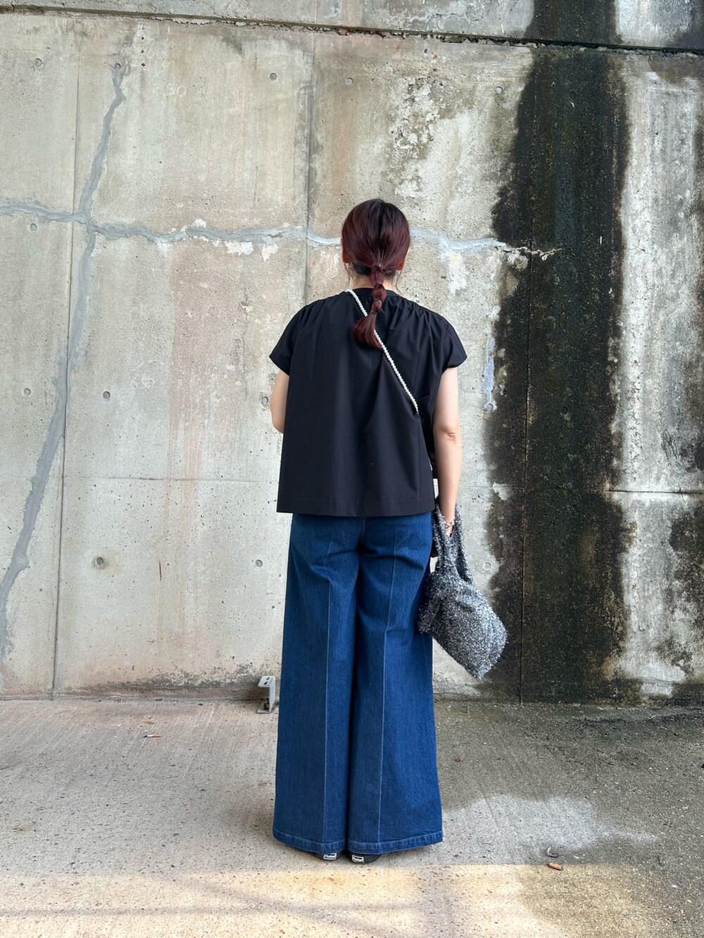 ブラック系のシャツ/ブラウス、ブルー系のデニムパンツ、ブラック系のバックパック/リュックを着用したレディースの夏コーディネートの4枚目の写真