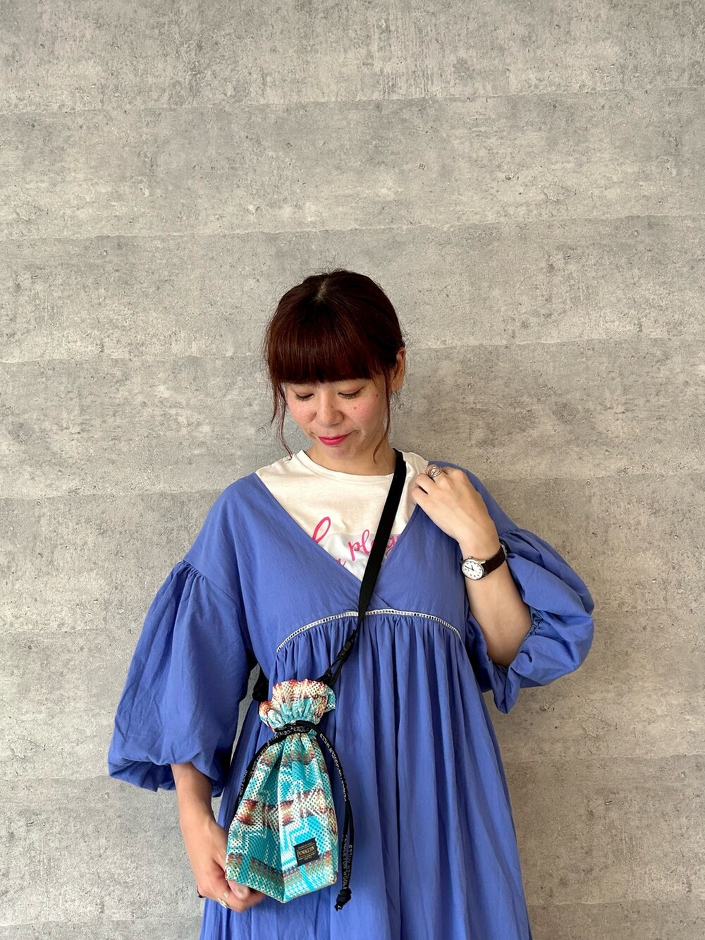 ブルー系のワンピース、ホワイト系のTシャツ/カットソー、ブルー系のショルダーバッグを着用したレディースの春コーディネートの2枚目の写真