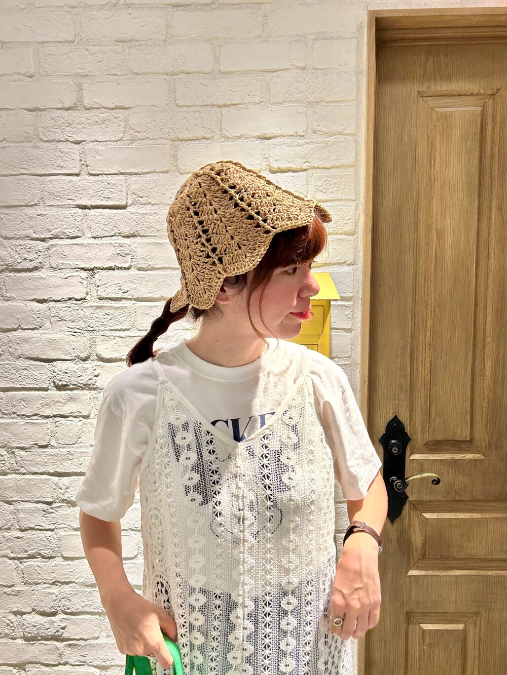 ブラック系のスニーカー、ホワイト系のTシャツ/カットソー、ブルー系のデニムパンツを着用したレディースの夏コーディネートの2枚目の写真