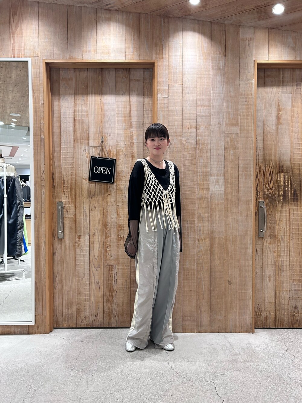 ホワイト系のベスト、ブラック系のTシャツ/カットソー、グレー系のスウェットパンツを着用したレディースの春コーディネートの4枚目の写真