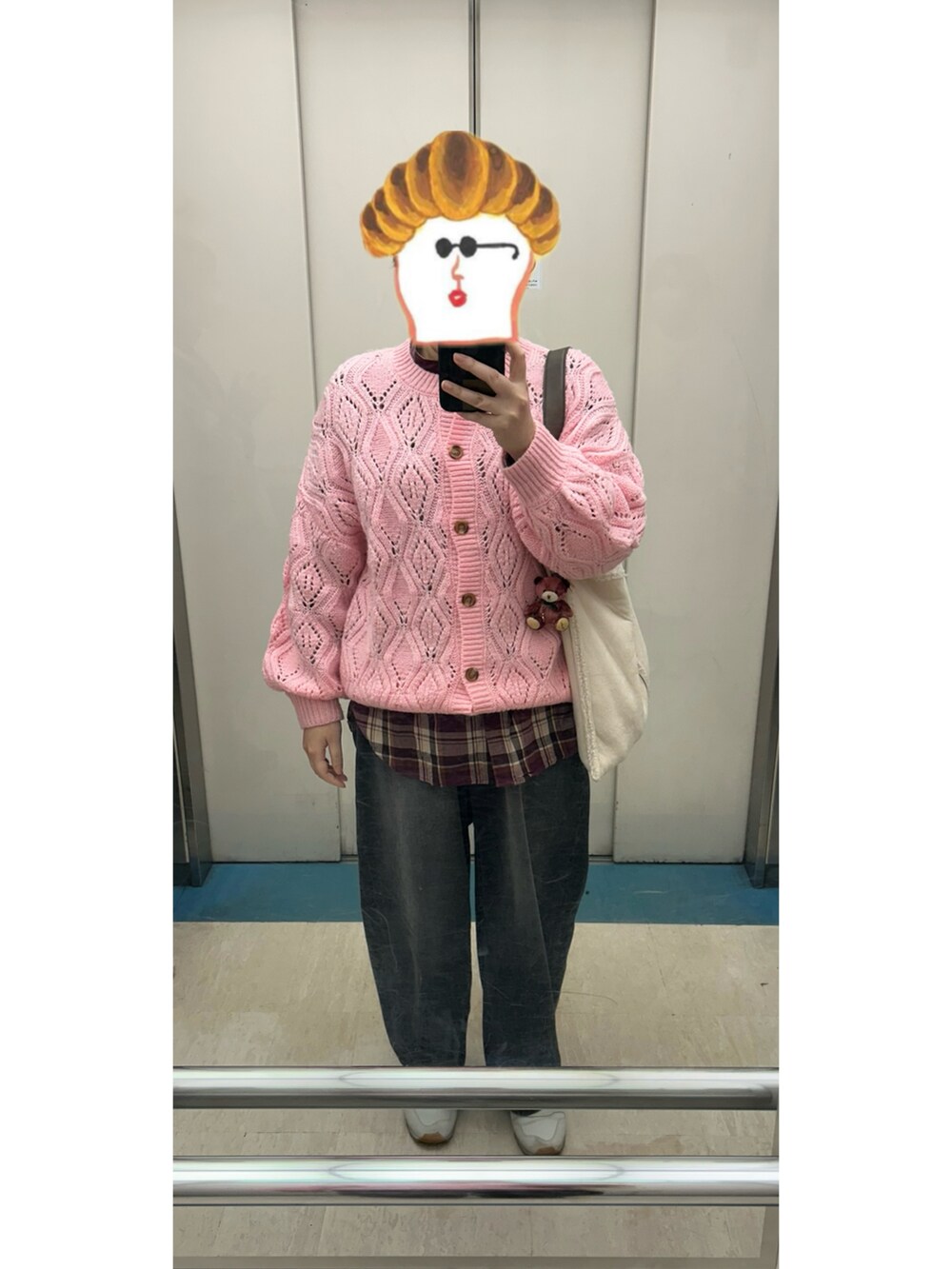 ピンク系のカーディガン/ボレロ、レッド系のシャツ/ブラウス、ブラック系のデニムパンツを着用したレディースの冬コーディネートの2枚目の写真