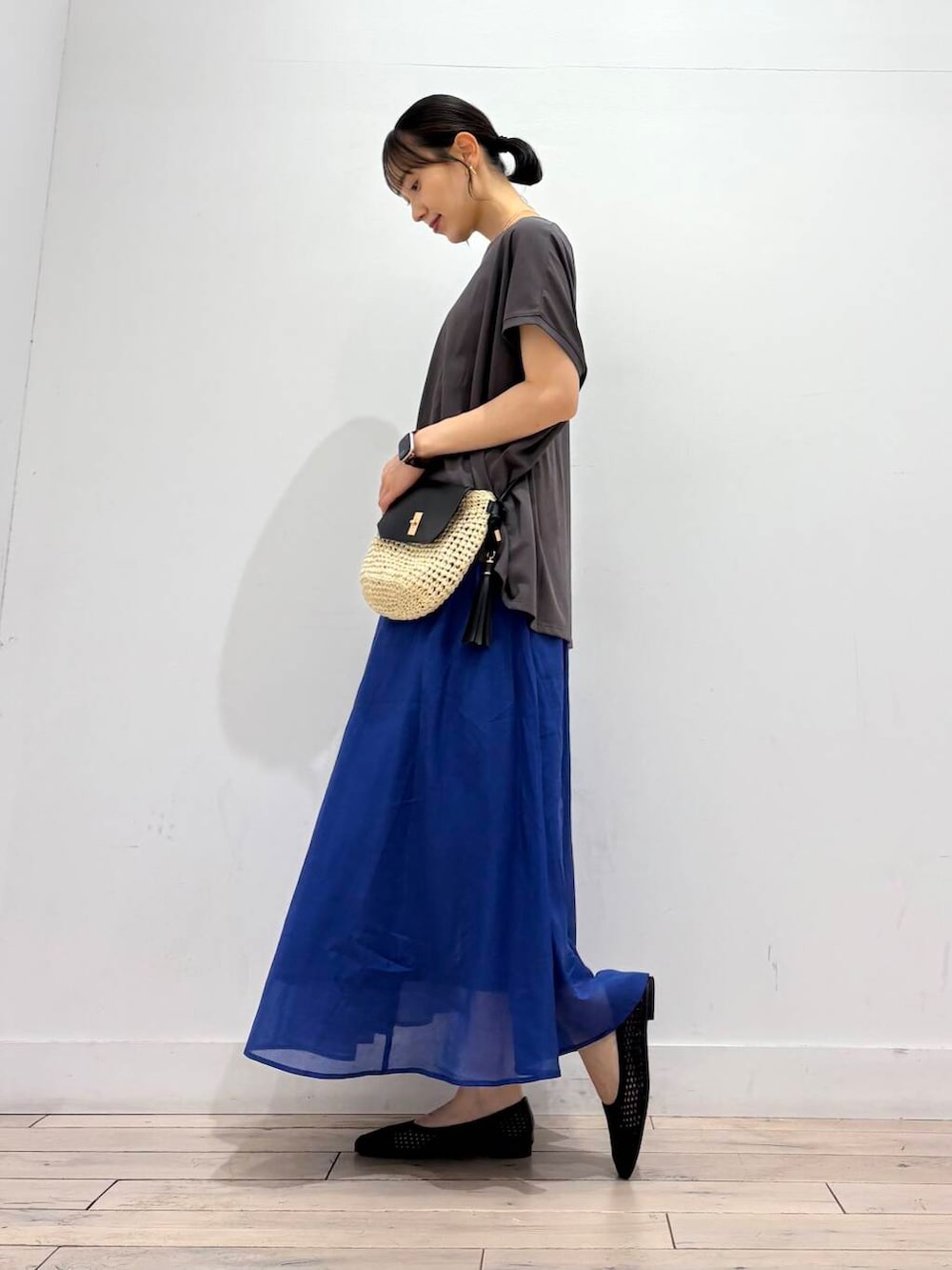 ベージュ系のショルダーバッグ、ブラック系のバレエシューズ、グレー系のTシャツ/カットソーを着用したレディースの夏コーディネートの2枚目の写真