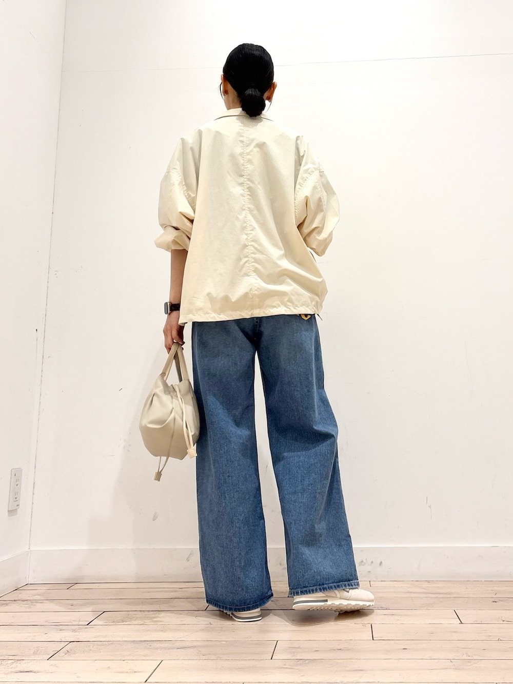 ブラック系のTシャツ/カットソー、ホワイト系のブルゾン、ホワイト系のスニーカーを着用したレディースの春コーディネートの5枚目の写真