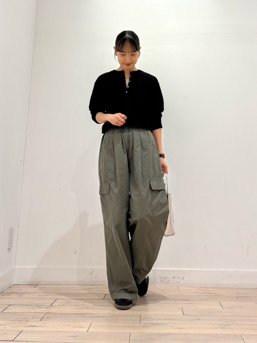 ブラック系のTシャツ/カットソー、グリーン系のその他パンツ、シルバー系のトートバッグを着用したレディースの秋コーディネートの2枚目の写真