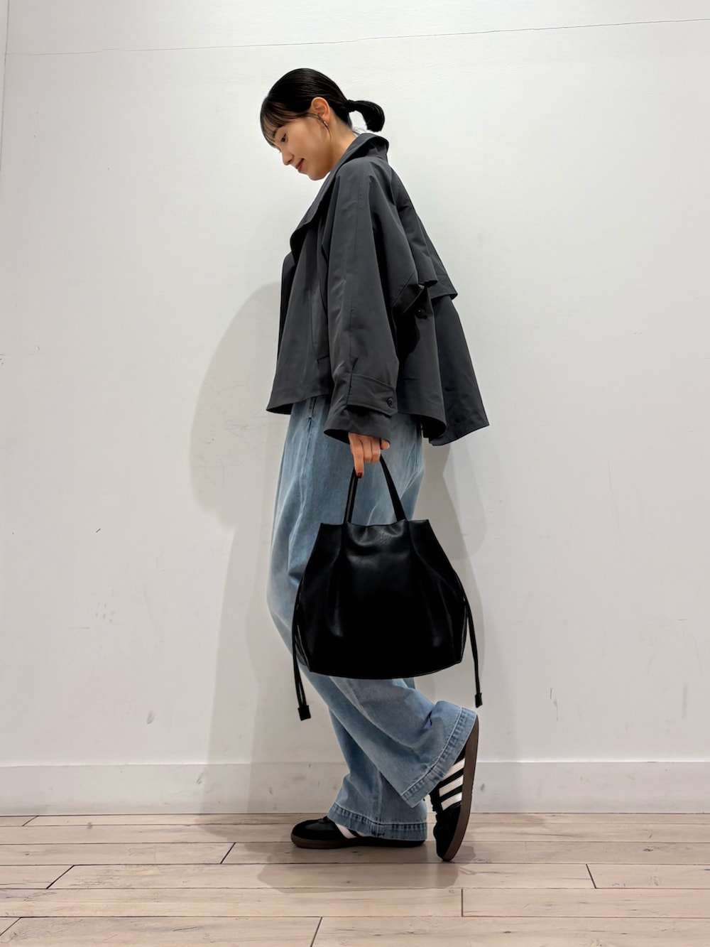 グリーン系のニット/セーター、グレー系のその他アウター、ブラック系のショルダーバッグを着用したレディースの春コーディネートの4枚目の写真