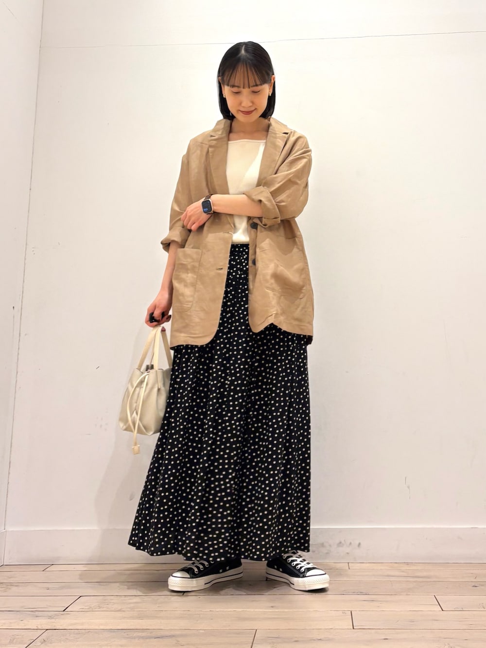 ホワイト系のタンクトップ、ブラック系のジャケット/アウター、ブラック系のスニーカーを着用したレディースの春コーディネートの3枚目の写真