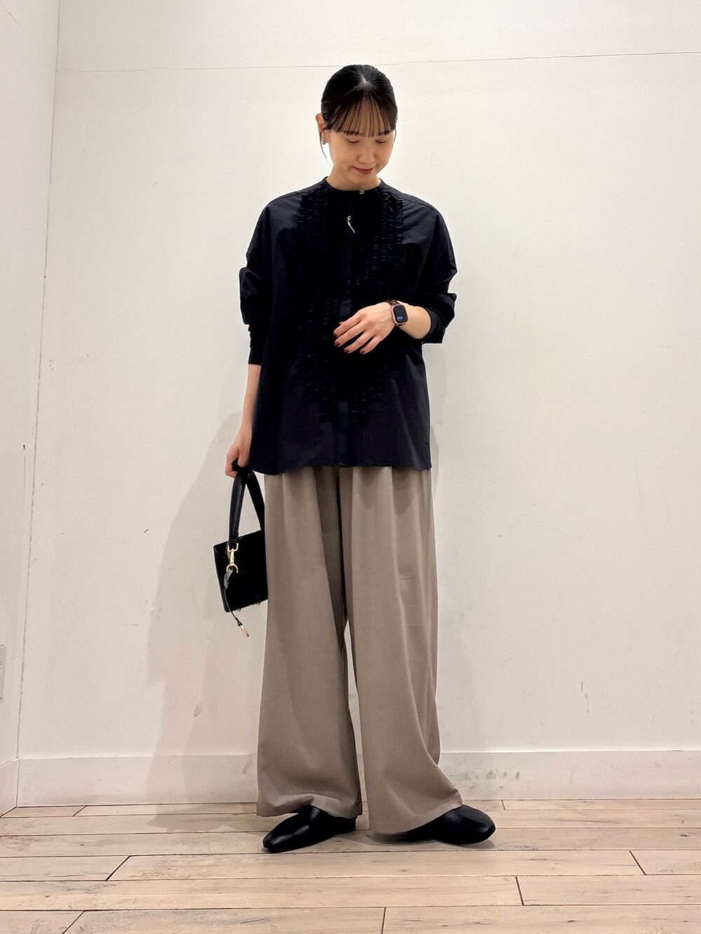 ブルー系のシャツ/ブラウス、ブラック系のショルダーバッグ、グレー系のその他パンツを着用したレディースの春コーディネートの2枚目の写真