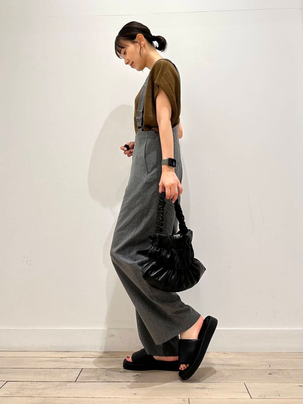 ブラック系のハンドバッグ、ブラック系のサンダル、ブラウン系のニット/セーターを着用したレディースの夏コーディネートの3枚目の写真