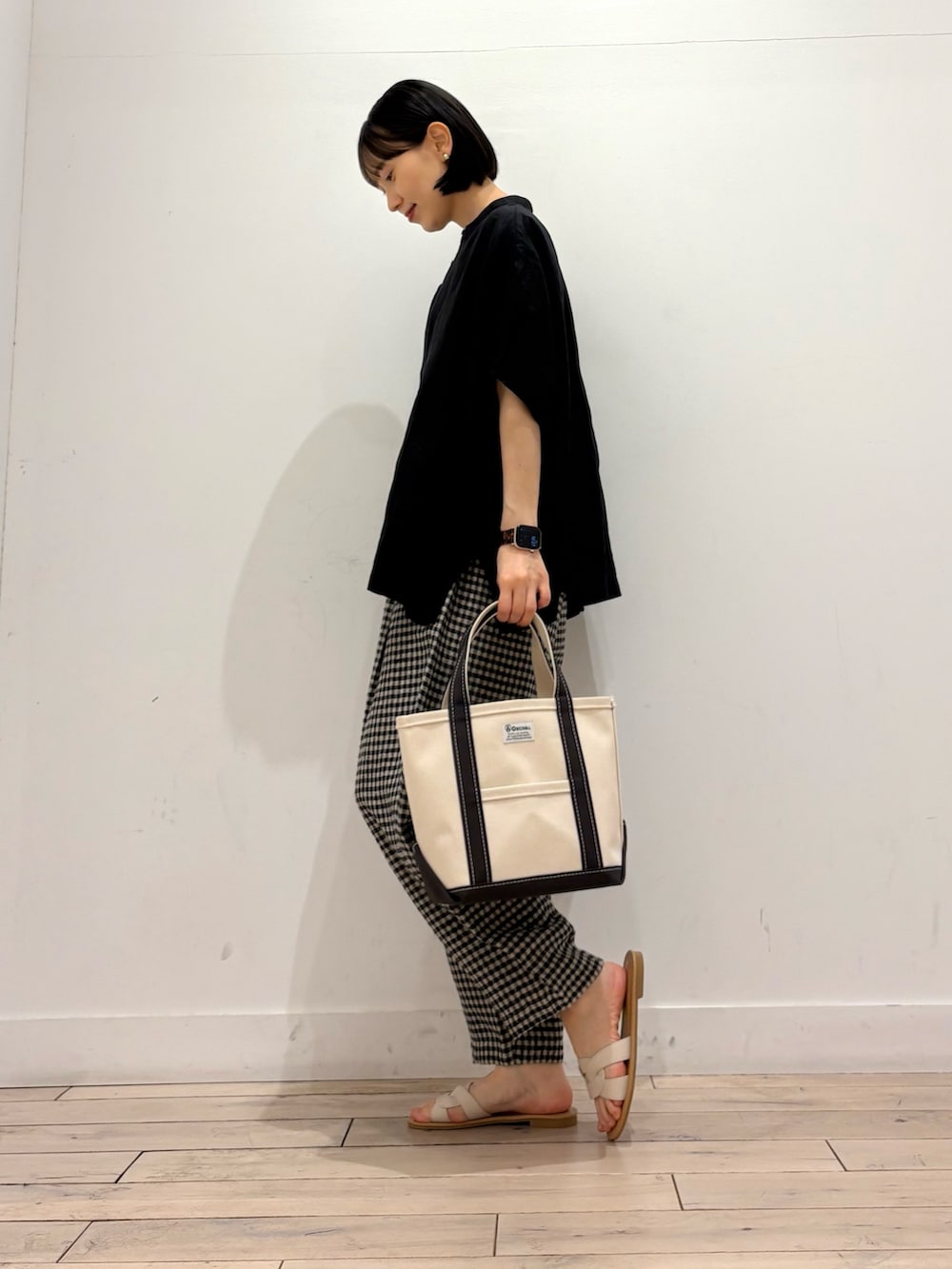 ブラック系のシャツ/ブラウス、ブラック系のその他パンツ、グレー系のトートバッグを着用したレディースの春コーディネートの3枚目の写真