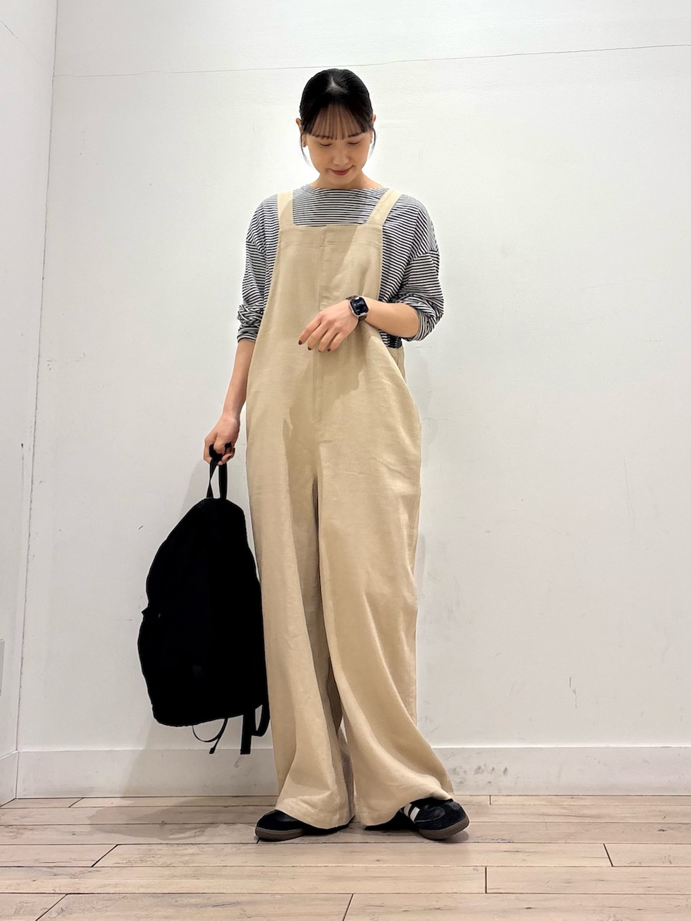 ブラック系のTシャツ/カットソー、ブラック系のバックパック/リュック、ブラック系のスニーカーを着用したレディースの春コーディネートの2枚目の写真