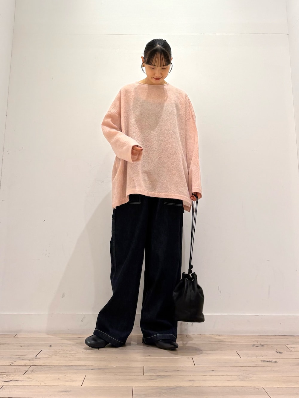 ピンク系のシャツ/ブラウス、ブルー系のデニムパンツ、ブラック系のショルダーバッグを着用したレディースの秋コーディネートの2枚目の写真