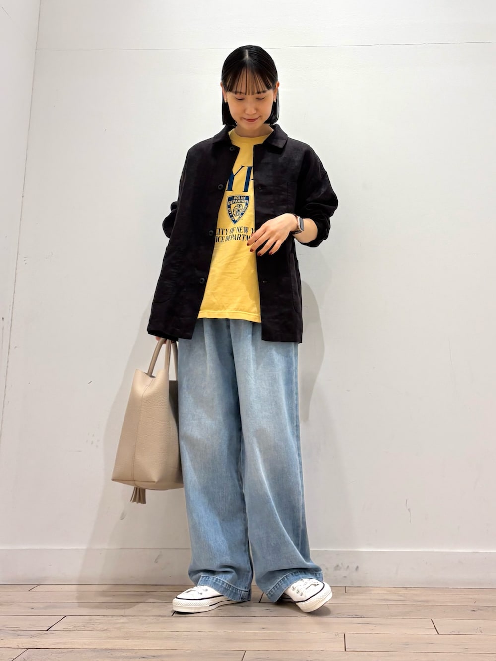 グレー系のカバーオール、ホワイト系のトートバッグ、ホワイト系のスニーカーを着用したレディースの春コーディネートの2枚目の写真