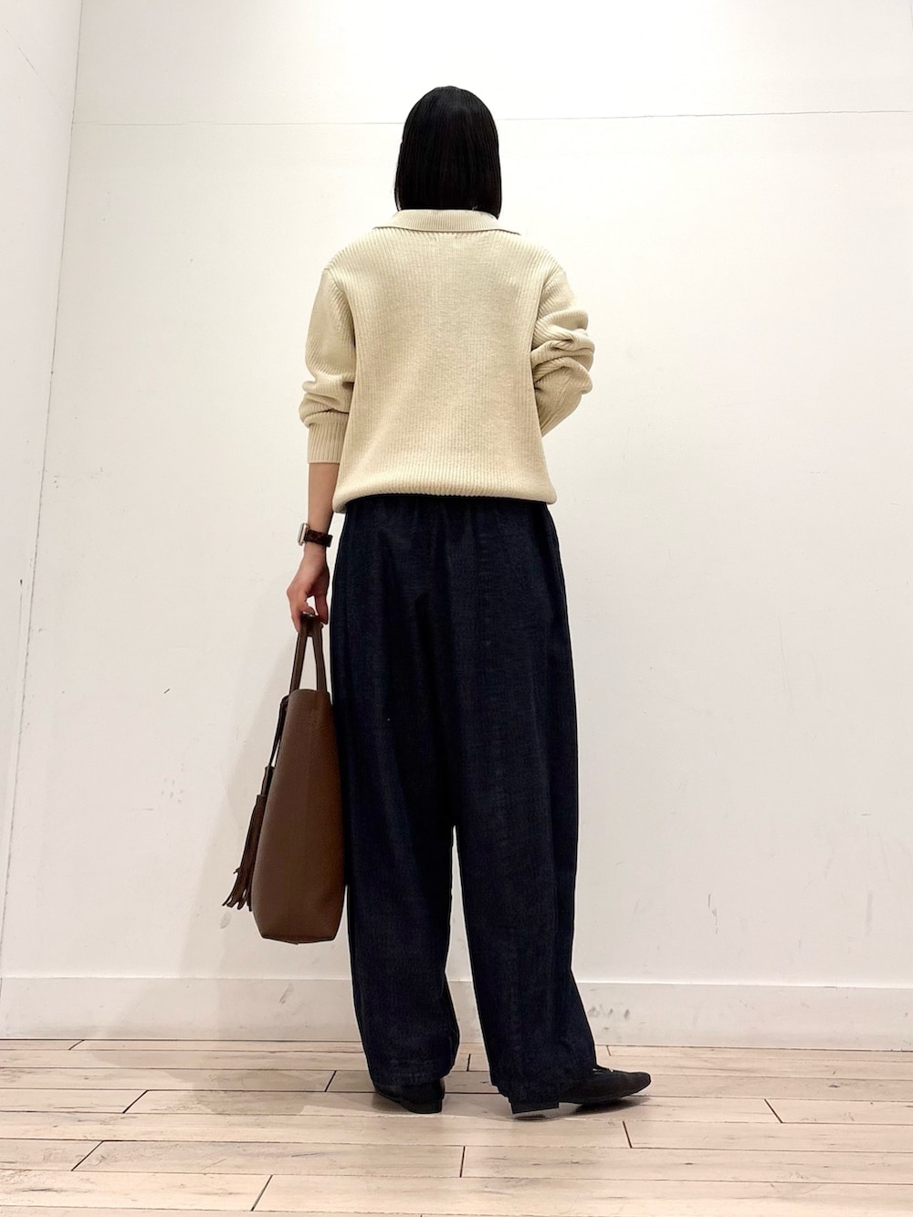 ホワイト系のニット/セーター、ブルー系のデニムパンツ、ブラウン系のトートバッグを着用したレディースの冬コーディネートの3枚目の写真