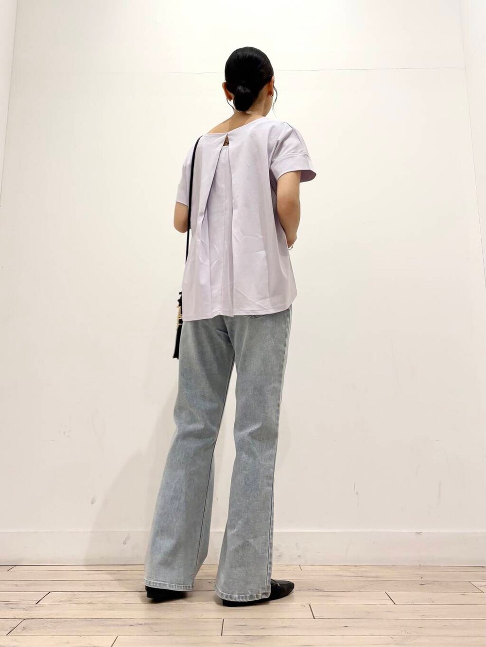 ブラック系のローファー、ベージュ系のショルダーバッグ、ブルー系のデニムパンツを着用したレディースの夏コーディネートの4枚目の写真