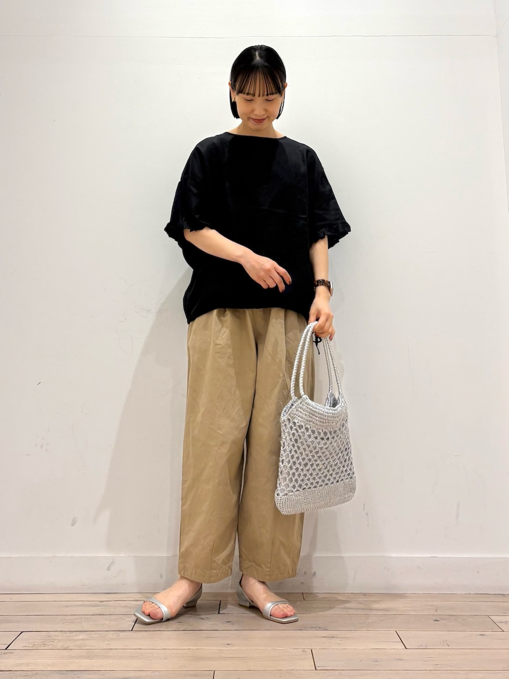 シルバー系のトートバッグ、シルバー系のサンダル、ベージュ系のその他パンツを着用したレディースの春コーディネートの3枚目の写真