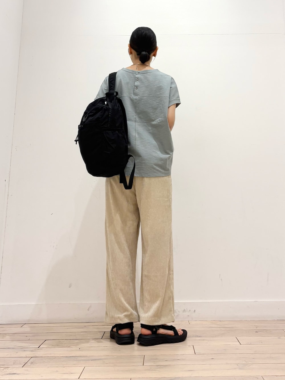 グリーン系のTシャツ/カットソー、ベージュ系のその他パンツ、ブラック系のバックパック/リュックを着用したレディースの夏コーディネートの3枚目の写真