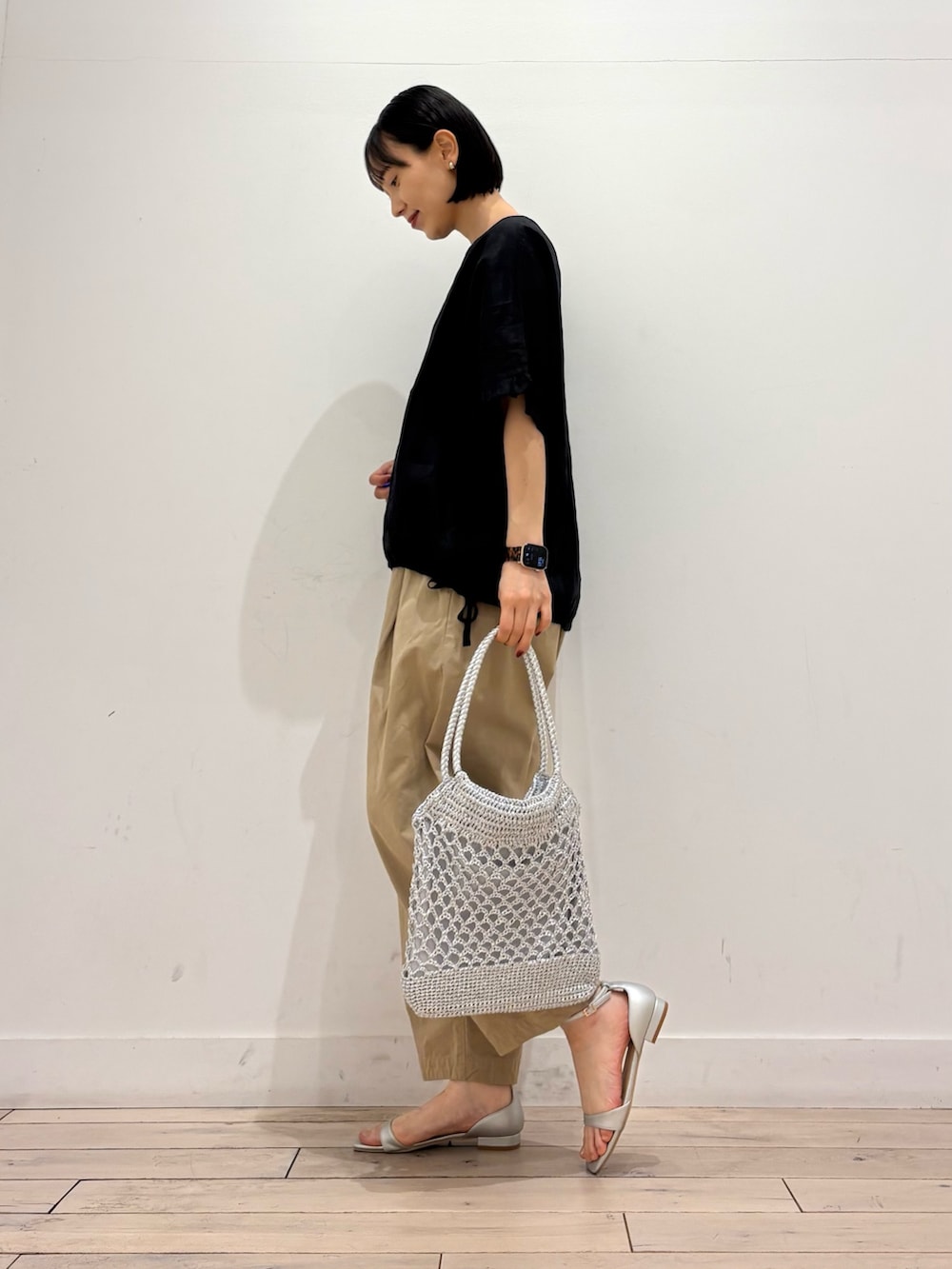 シルバー系のトートバッグ、シルバー系のサンダル、ベージュ系のその他パンツを着用したレディースの春コーディネートの4枚目の写真