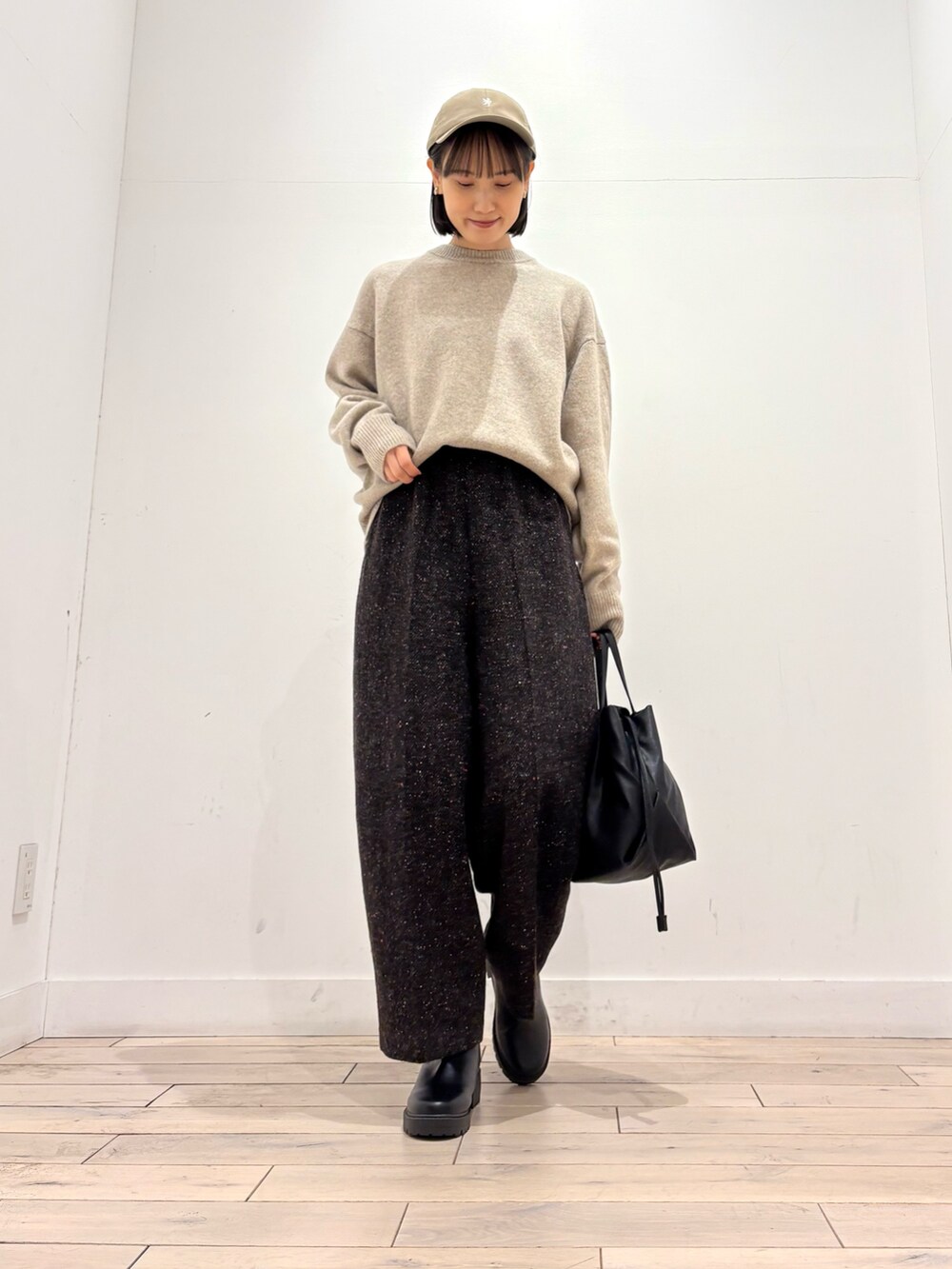 ブルー系のピーコート、ベージュ系のニット/セーター、ブラウン系のその他パンツを着用したレディースの冬コーディネートの2枚目の写真